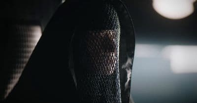 a close up of a person wearing a black hoodie