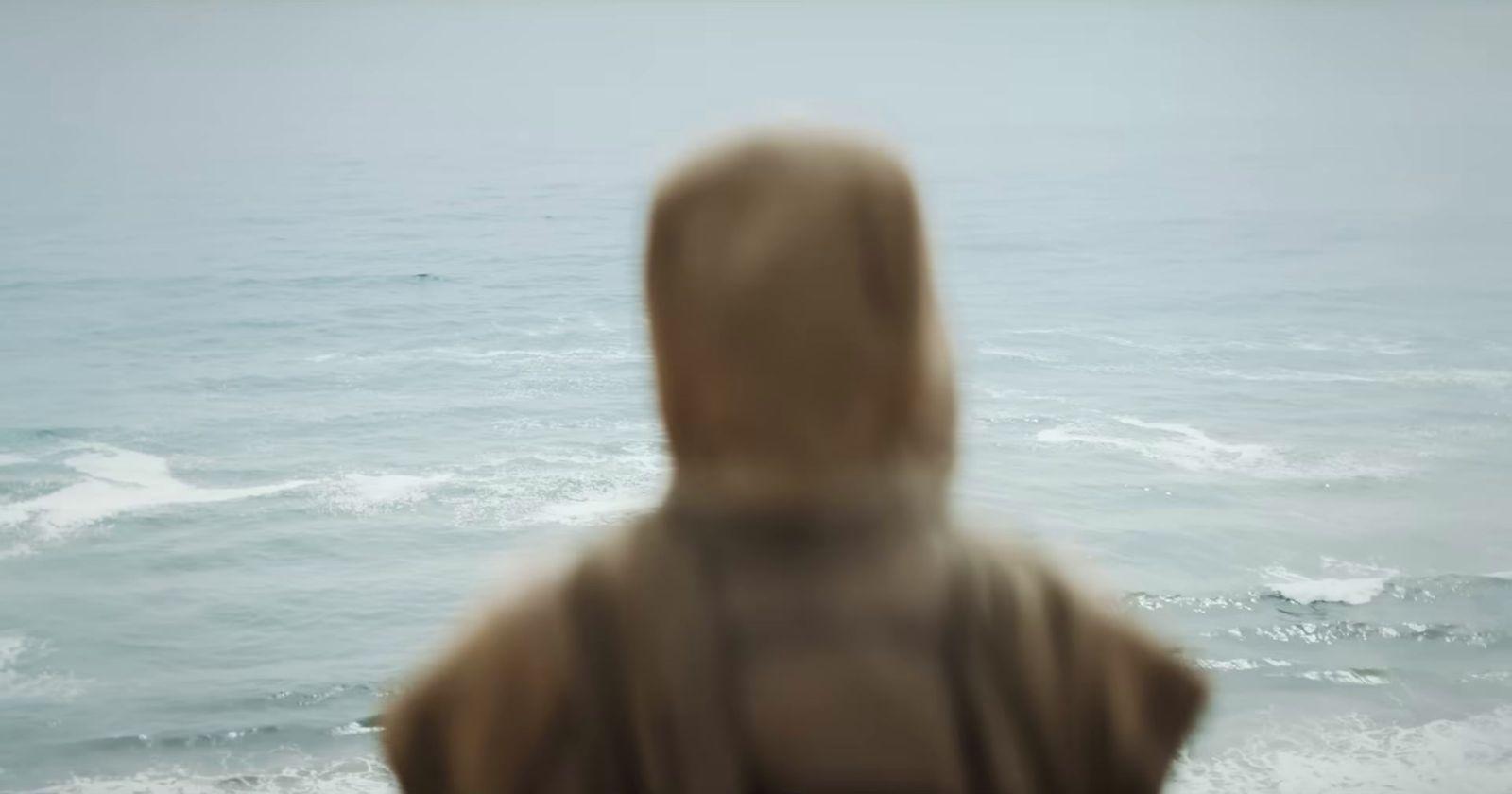 a blurry photo of a person standing in front of a body of water