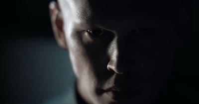 a close up of a person in a dark room