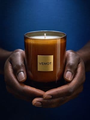 a person holding a candle in their hands