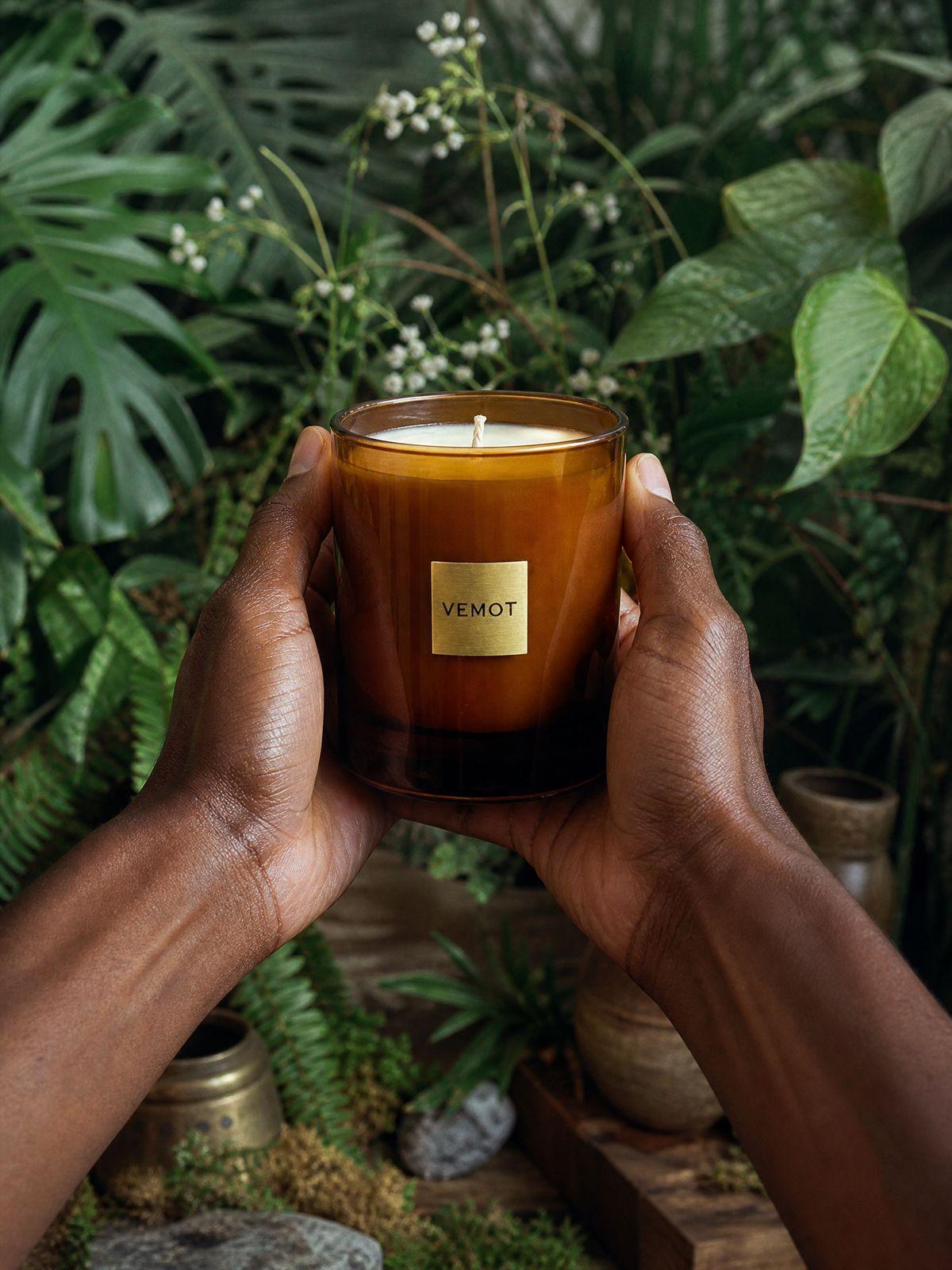 a person holding a candle in their hands