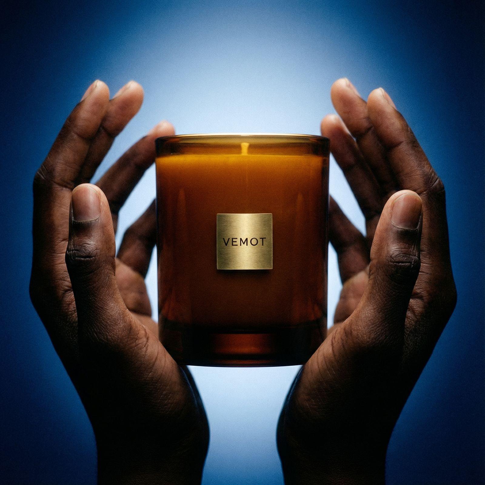 a person holding a candle in their hands