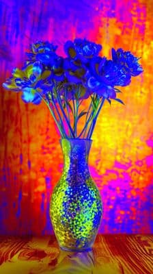 a vase filled with blue flowers on top of a table