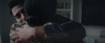 a man holding a gun in his right hand