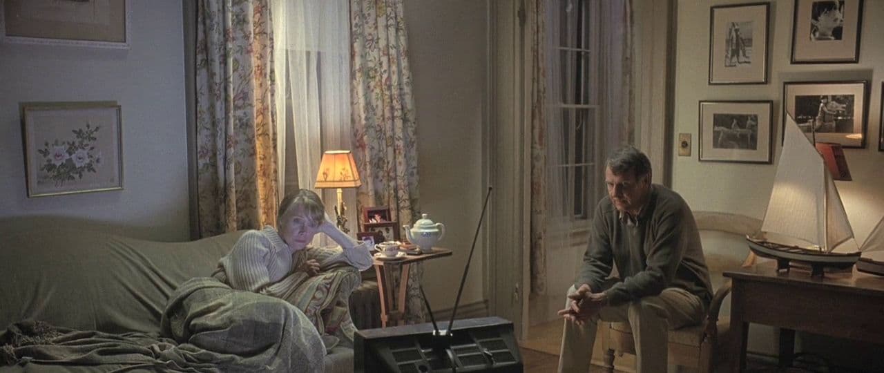 a man and a woman sitting on a couch in a living room
