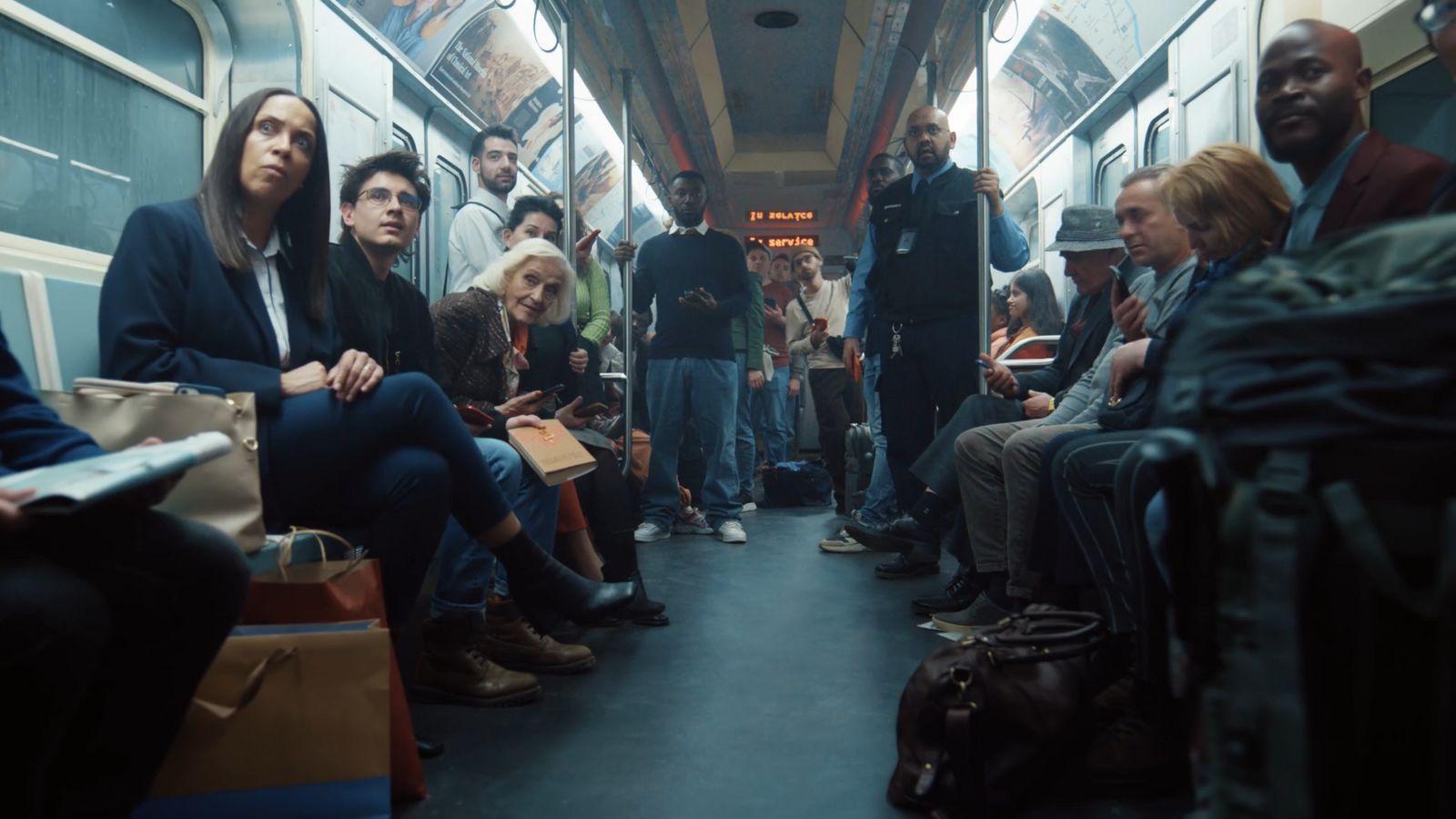 a group of people sitting on a subway car