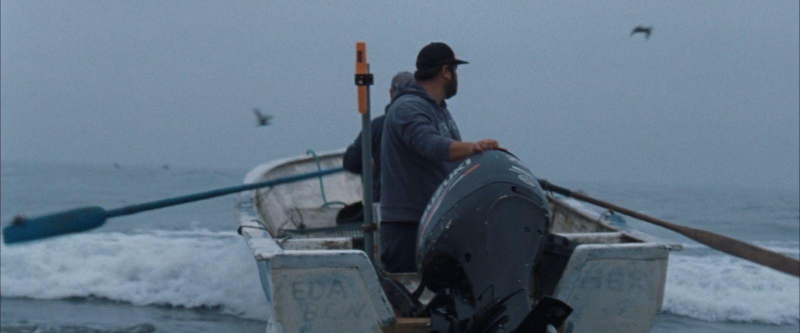 a man in a boat on the water
