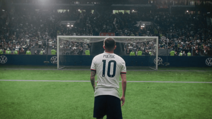 a man standing on a soccer field in front of a soccer goal