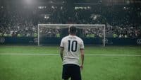 a man standing on a soccer field in front of a soccer goal