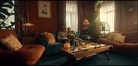 a man sitting on a couch in a living room