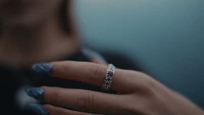 a woman's hand with a ring on it