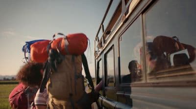 a group of people getting on a bus