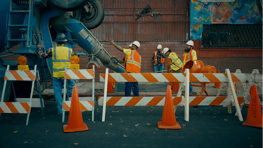 a group of construction workers standing around a construction site