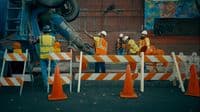 a group of construction workers standing around a construction site