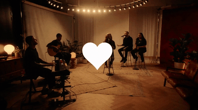 a group of people sitting in a room with a heart cut out in the middle