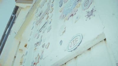 a wall with a lot of stickers on it