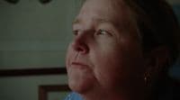 a woman with blue eyes looking off into the distance