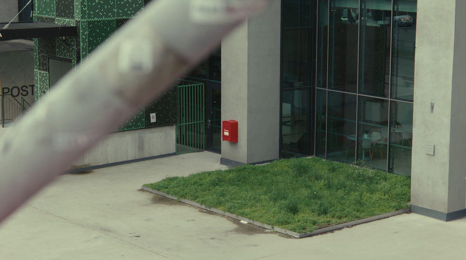 a building with a grassy area in front of it