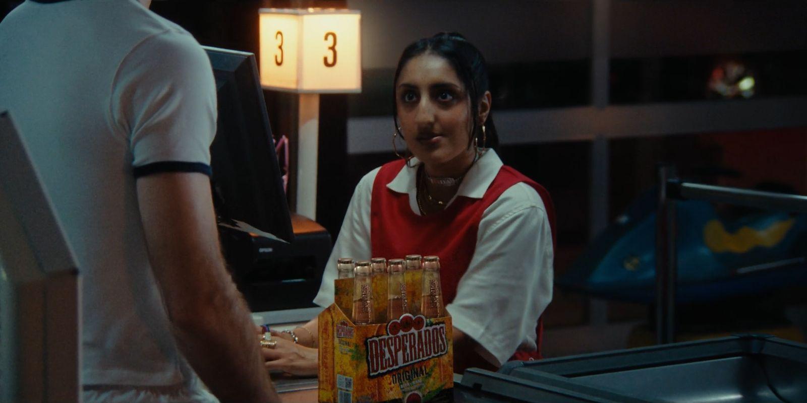 a man standing next to a woman holding a box of orange juice
