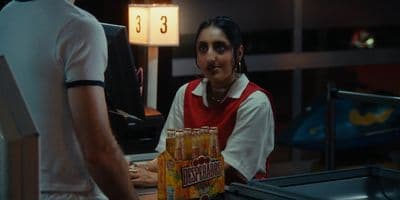 a man standing next to a woman holding a box of orange juice