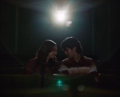 a man and a woman standing in a dark room