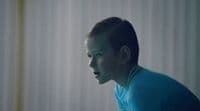 a boy in a blue shirt is staring at something