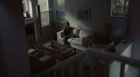 a person sitting on a couch in a living room