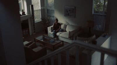 a person sitting on a couch in a living room
