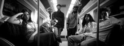 a group of people sitting on a train next to each other