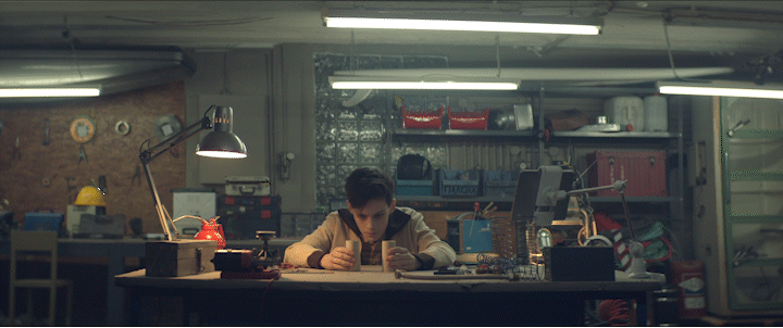 a man sitting at a desk working on a laptop