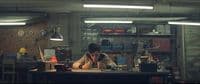 a man sitting at a desk working on a laptop