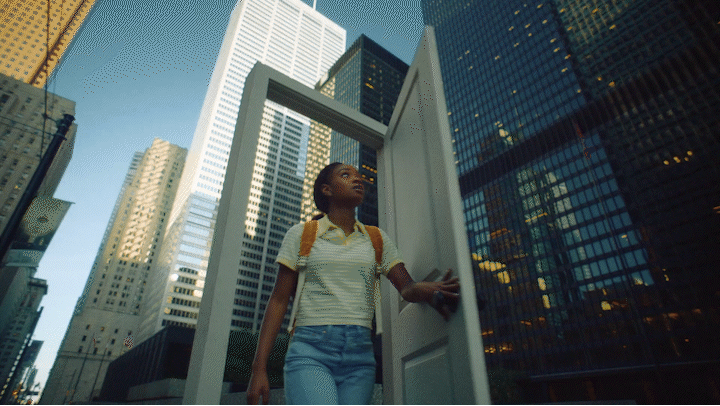 a woman standing in a doorway in a city