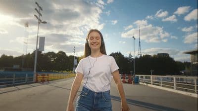 a woman in a white shirt is skateboarding