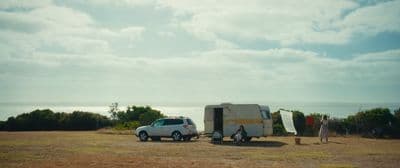 a van is parked next to a trailer