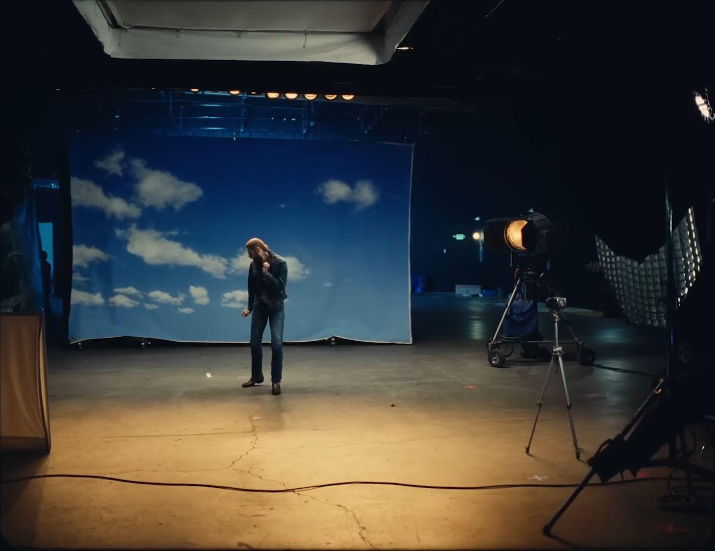 a woman standing in front of a camera on a stage