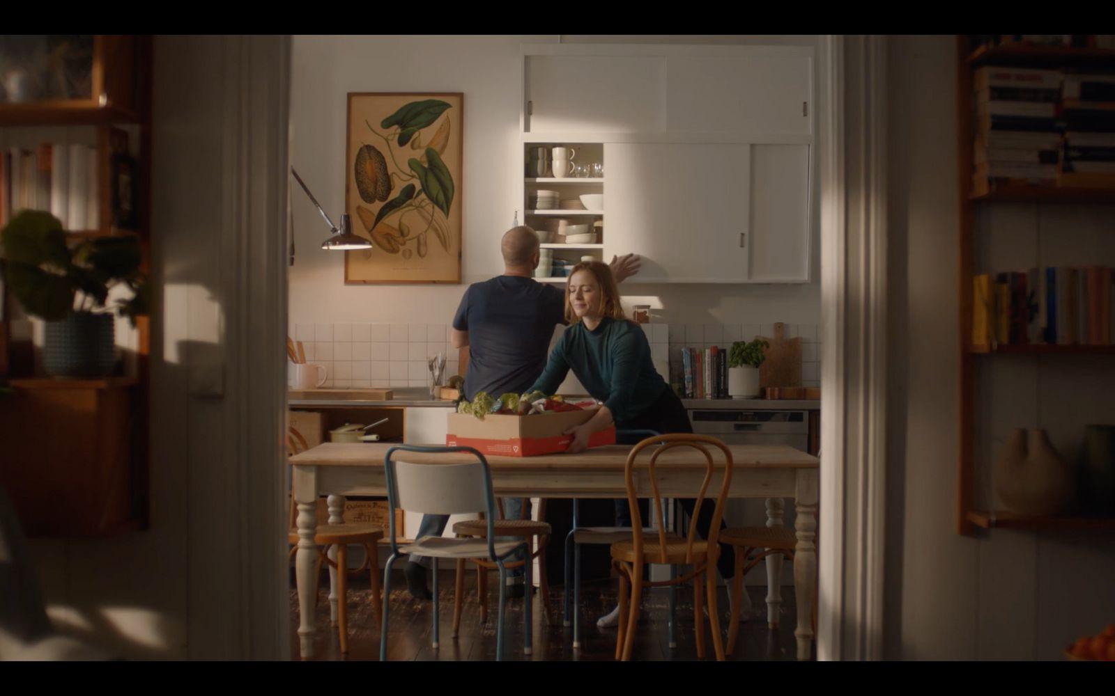 a man and a woman standing in a kitchen
