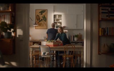 a man and a woman standing in a kitchen