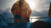 a man standing on a boat in the water