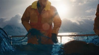 a man standing on a boat in the water