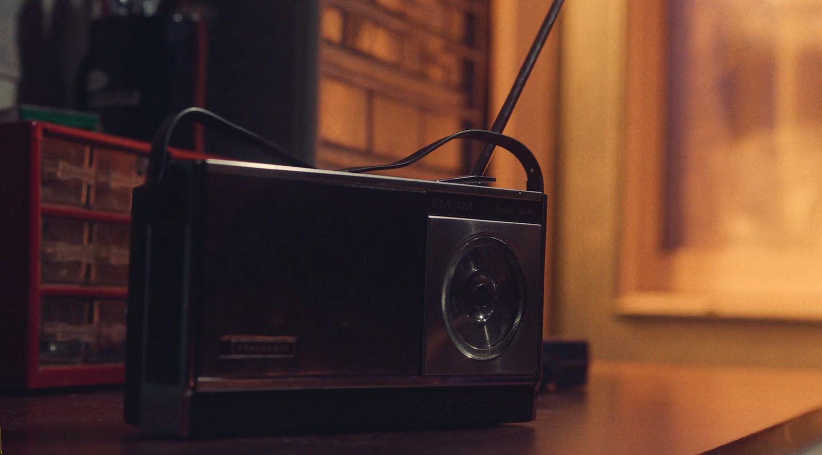 a black radio sitting on top of a wooden table