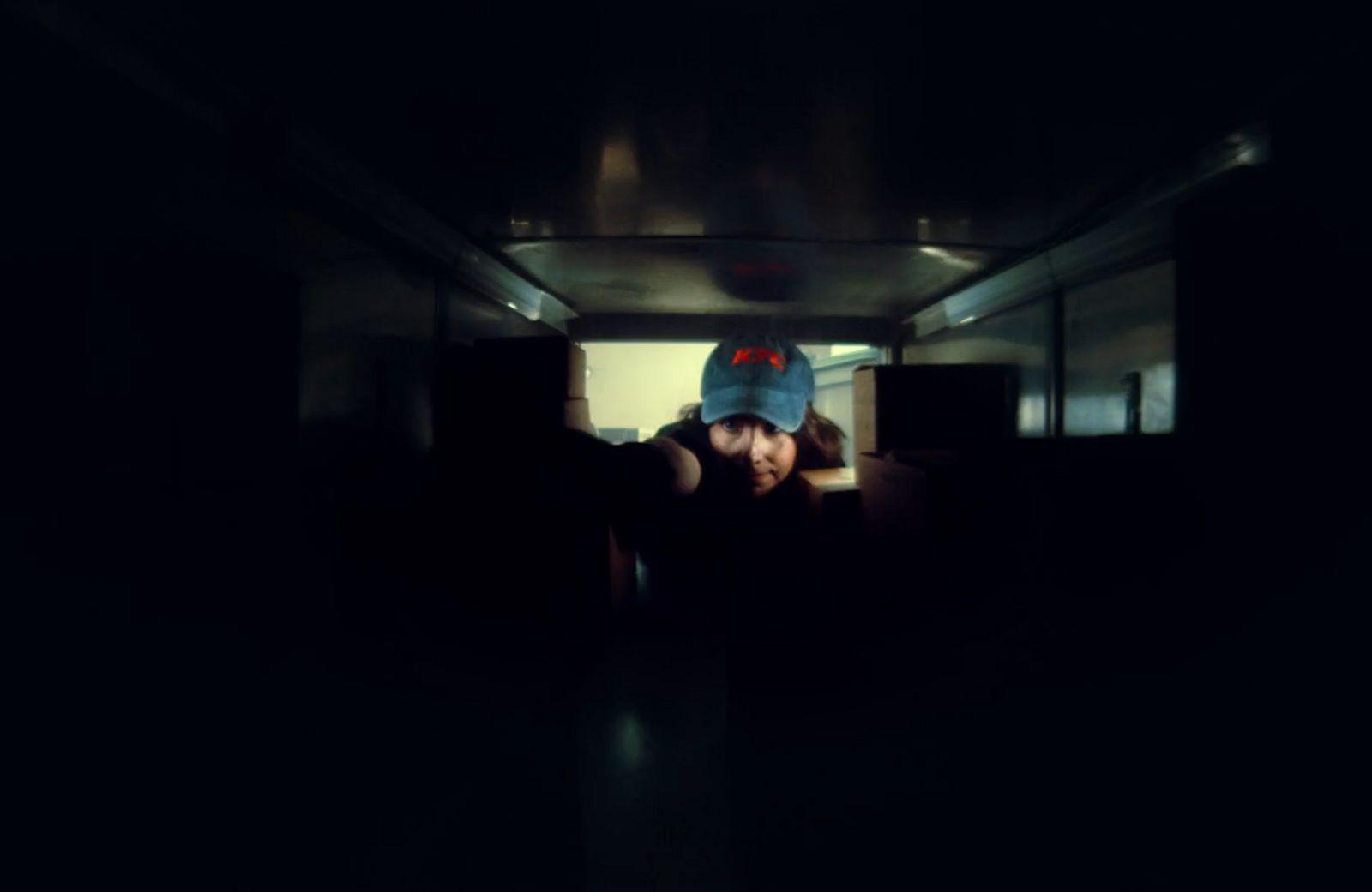 a person wearing a blue hat in a dark room