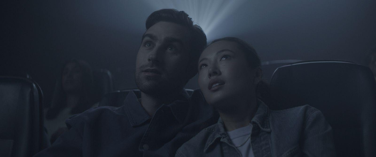 a man and a woman sitting in a movie theater