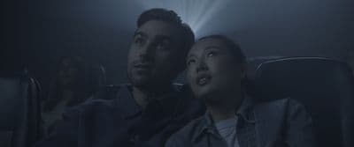a man and a woman sitting in a movie theater