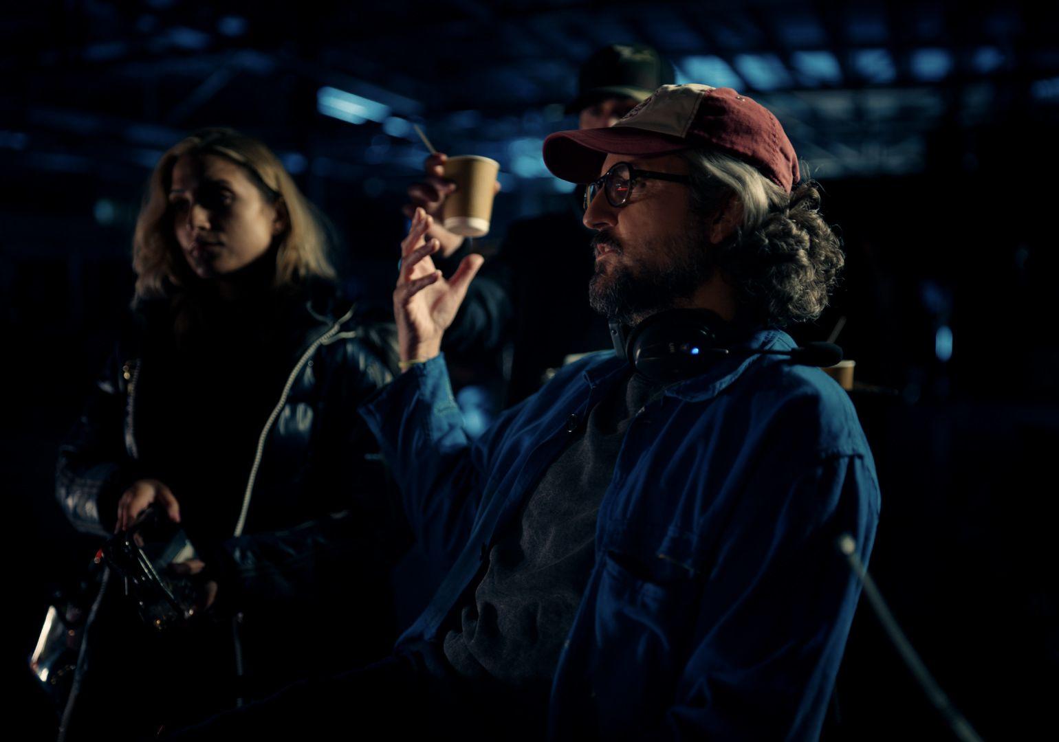 a man in a red hat is holding a cup