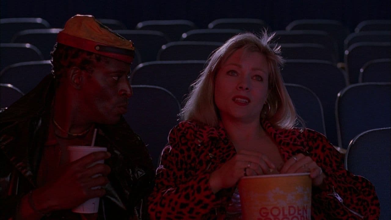 a man and a woman sitting in a movie theater