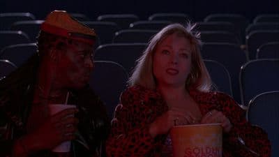 a man and a woman sitting in a movie theater