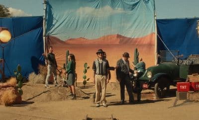 a group of people standing in front of a desert scene