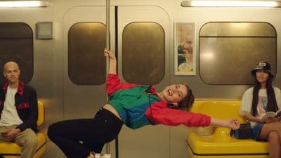 a woman in a red and green shirt is on a yellow bench