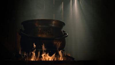 a large pot sitting on top of a fire pit