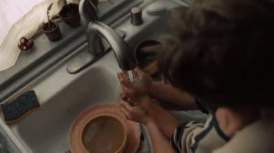 a person washing their hands in a sink